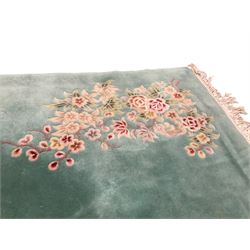 Chinese pale turquoise ground washed woolen rug, the plain field decorated with two large floral bouquet motifs with extending blossom and leafage