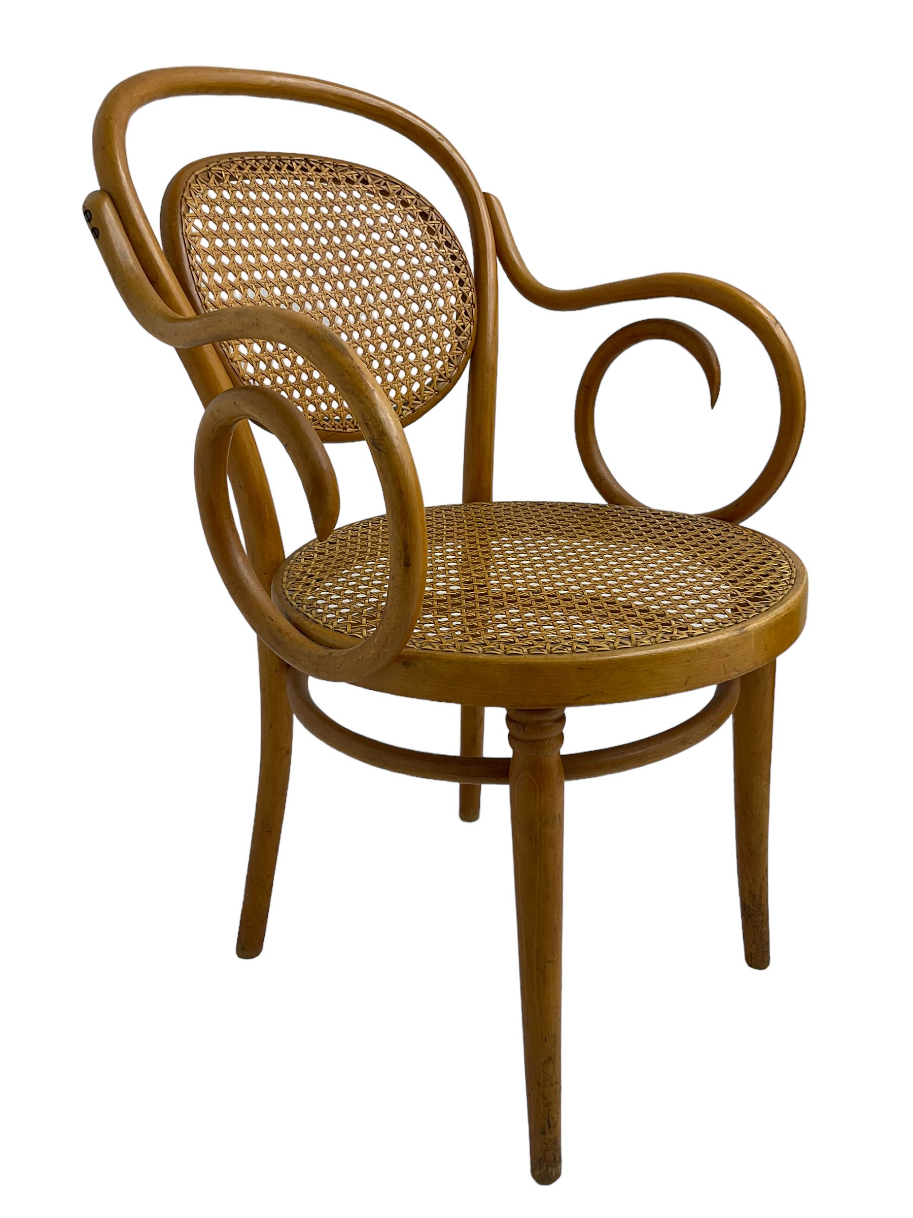 After Michael Thonet - bentwood armchair, circular cane seat and back, scrolled arms