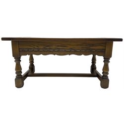 Old Charm - oak coffee table, rectangular top with glass inset over carved scalloped apron, on turned square supports connected by H-stretcher