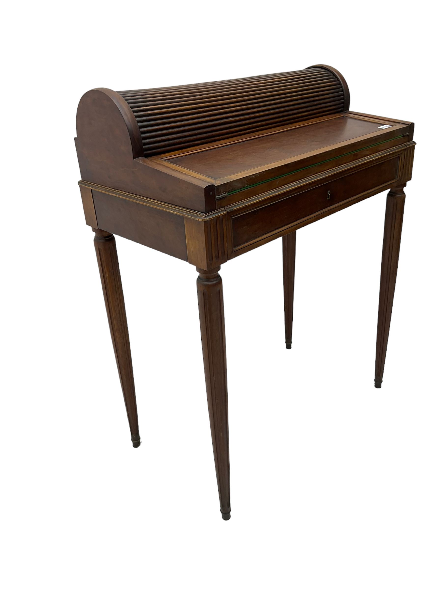 Early 20th century French plum pudding mahogany petite writing desk, barrel tambour roll top, fitted with a single cock-beaded drawer activating the tambour roll, the fold-over writing slope with inset writing surface supported by long drawer, fitted with three small drawers and pen rail, raised on fluted tapering supports