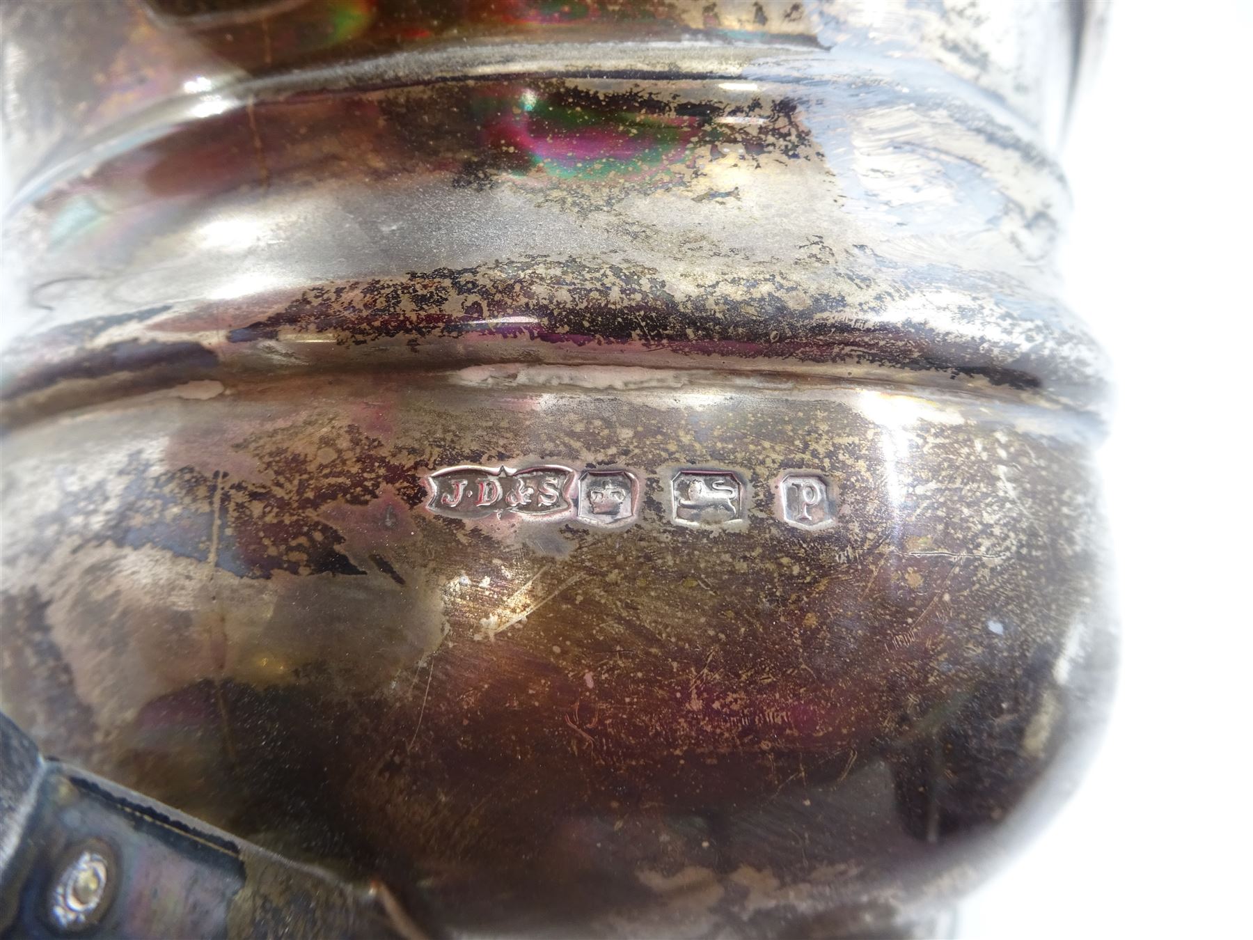 1930s silver three piece tea service, comprising teapot, open sucrier and milk jug, each of oval form with oblique gadrooned rim, the teapot with Bakelite handle and finial, hallmarked James Dixon & Sons Ltd, Sheffield 1932