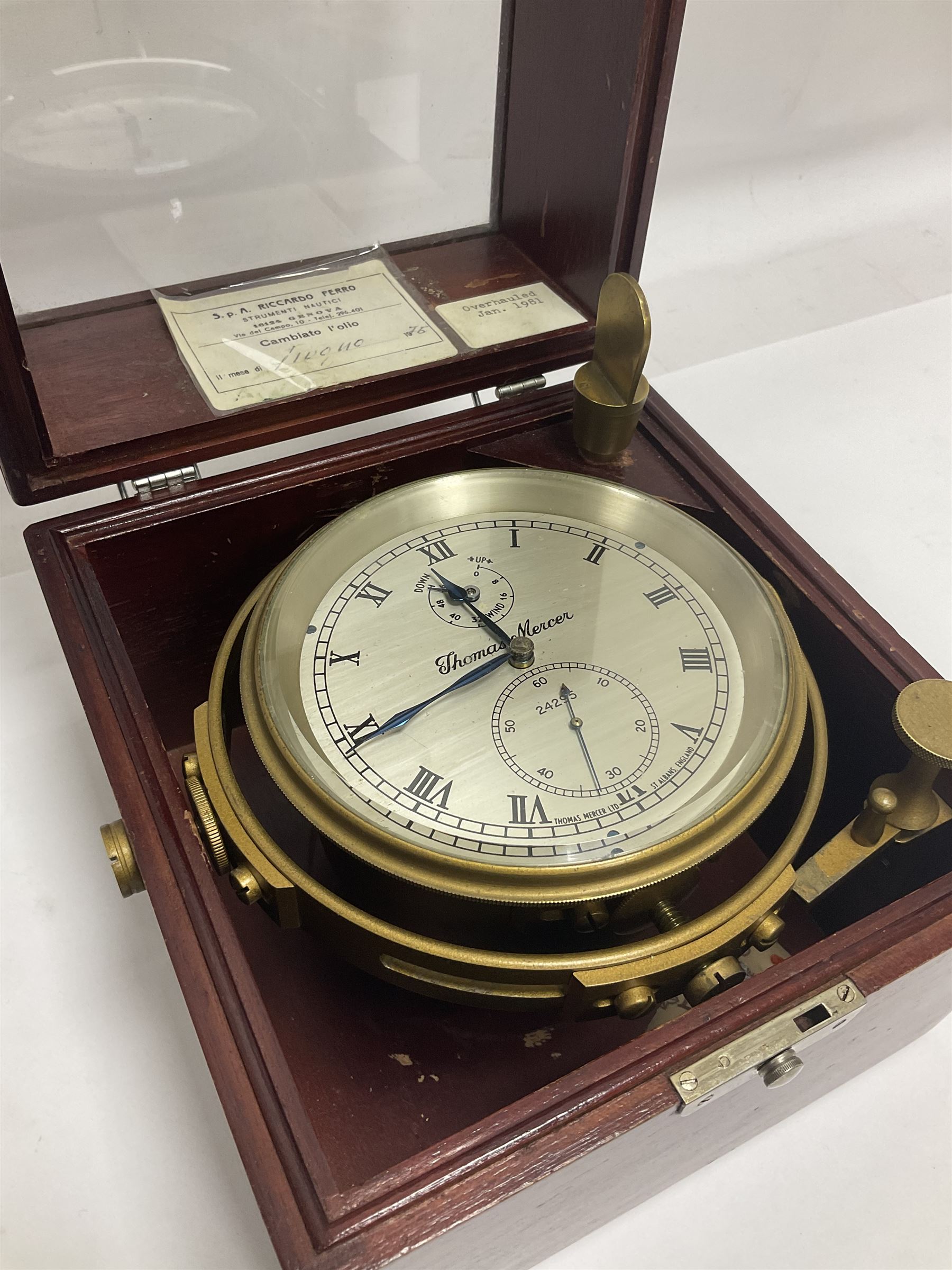 Two-day marine chronometer, with silvered dial inscribed Thomas Mercer Ltd, St Albans, contained within a brass gimbal-mounted bowl and glazed mahogany case, with applied brass plaque reading 'supplied by Kelvin Hughes no. 24295', brass winding key and two service notes to interior of case, dial D12cm, wooden case H17.5cm 