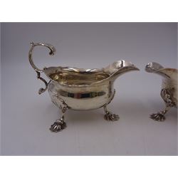 Near pair of George II silver sauce boats, each of oval form with shaped rim and capped flying scroll handle, upon three scroll mounted feet, hallmarked David Hennell, London 1758, H12cm