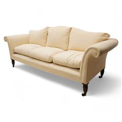 Grande three-seat camelback sofa, upholstered in calico base layer, on turned feet painted to resemble rosewood, fitted with brass cups and castors