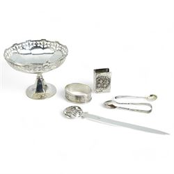 Small silver comport with inscription D10cm, 800 standard silver paper knife with pierced finial, silver matchbox holder, silver serviette ring, sugar tongs and salt spoon 