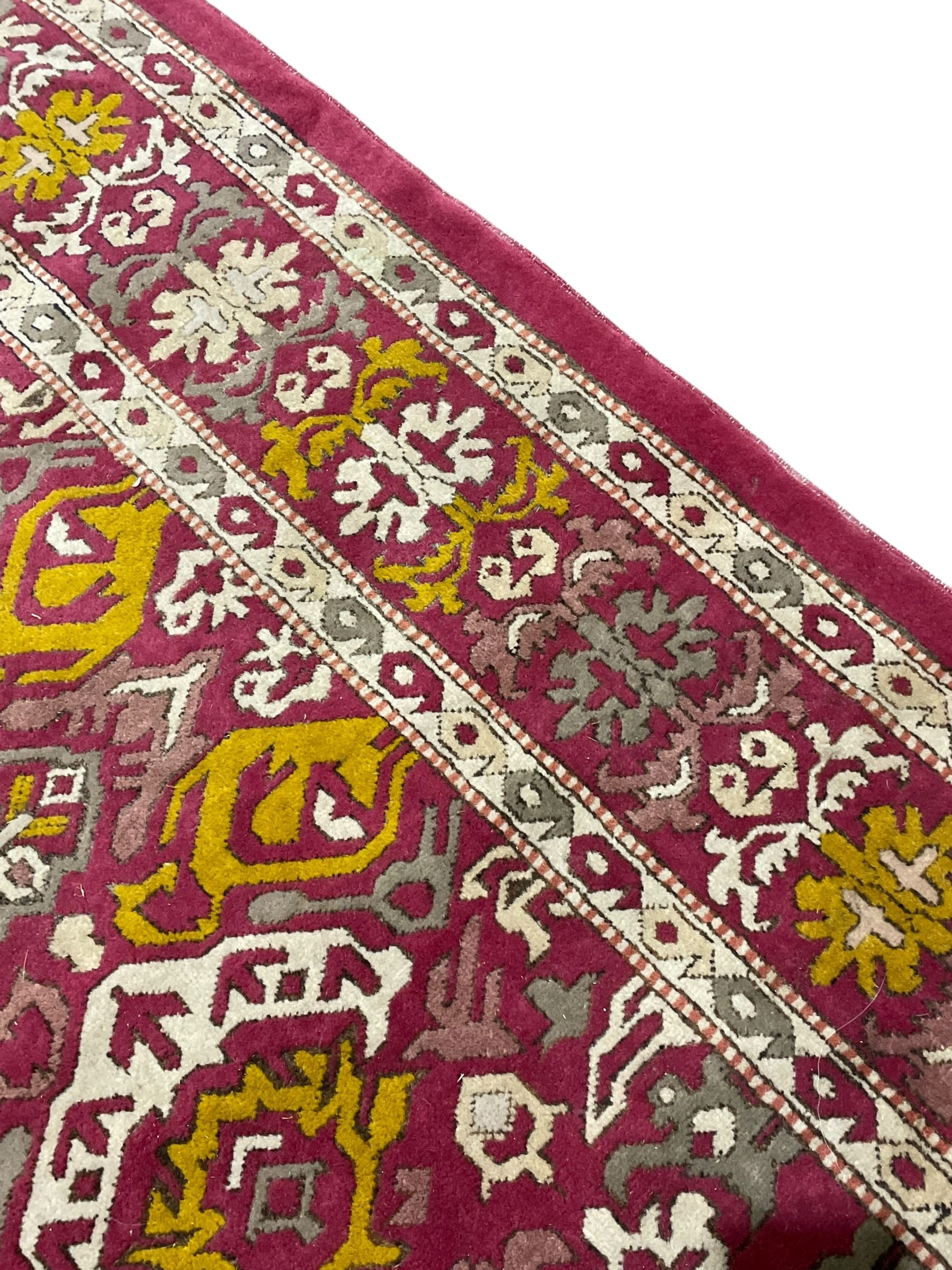 Persian design red ground rug, decorated with stylised plant motifs, repeating border within Boteh decorated guard stripes 