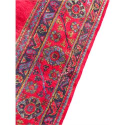 Early 20th century Western Anatolia Turkish Oushak crimson ground carpet, the field decorated with rows of Herati and Palmette medallions, the main border decorated with stylised flower head motifs within guard stripes