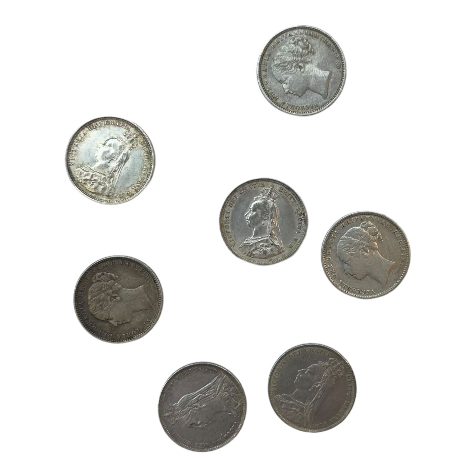 Seven Queen Victoria silver one shilling coins, dated 1880, 1883, 1884, two 1887, 1890 and 1892