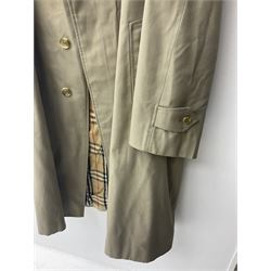 Ladies Burberry double breasted trench coat, with belt and detachable woollen gilet, in traditional cream colour with Burberry check lining, together with a gentlemans Burberry single breasted trench coat, both L112cm