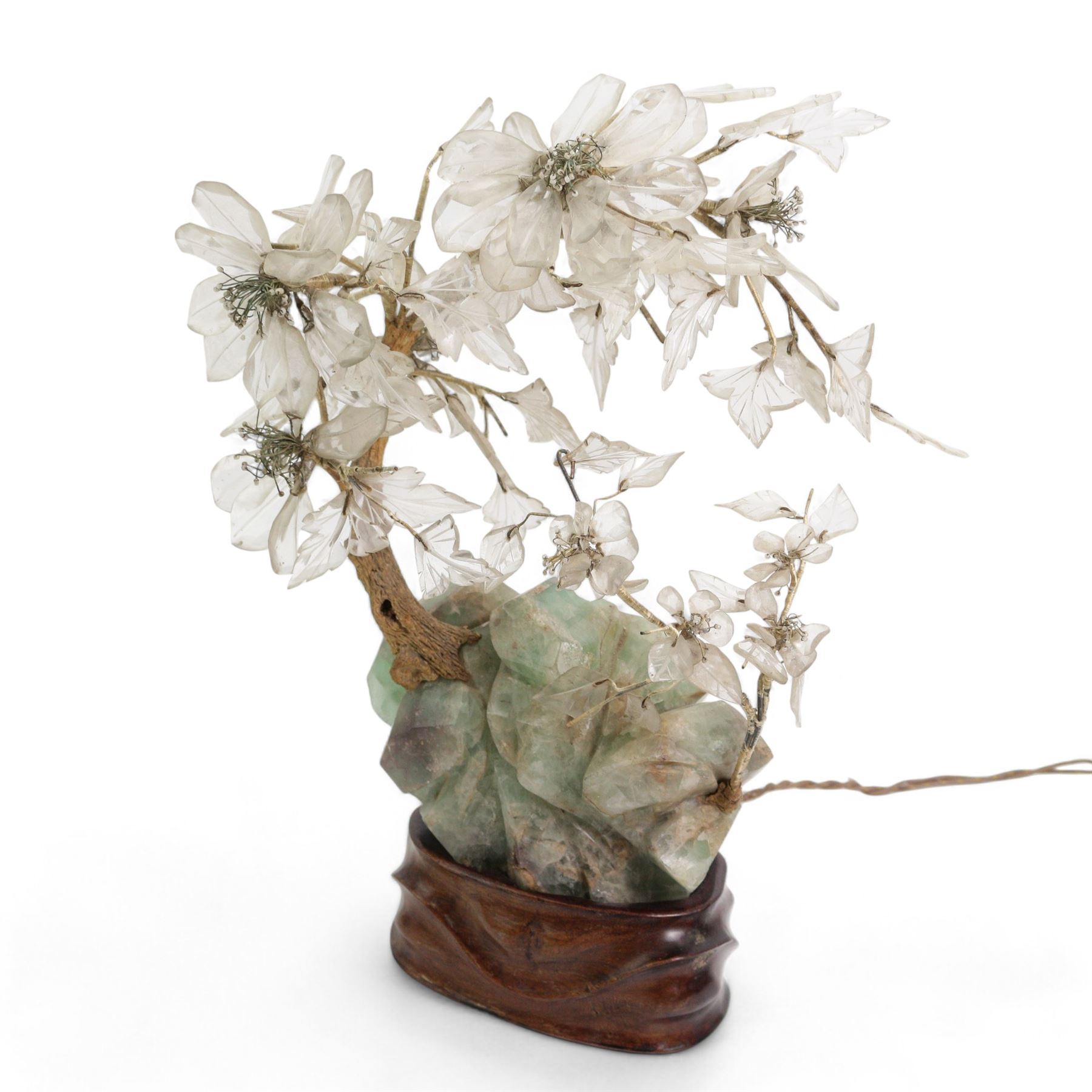 Early 20th century Chinese carved fluorite and crystal table lamp, depicting a blossoming tree on a rocky outcrop, on a carved hardwood stand inset with a bulb, H40cm