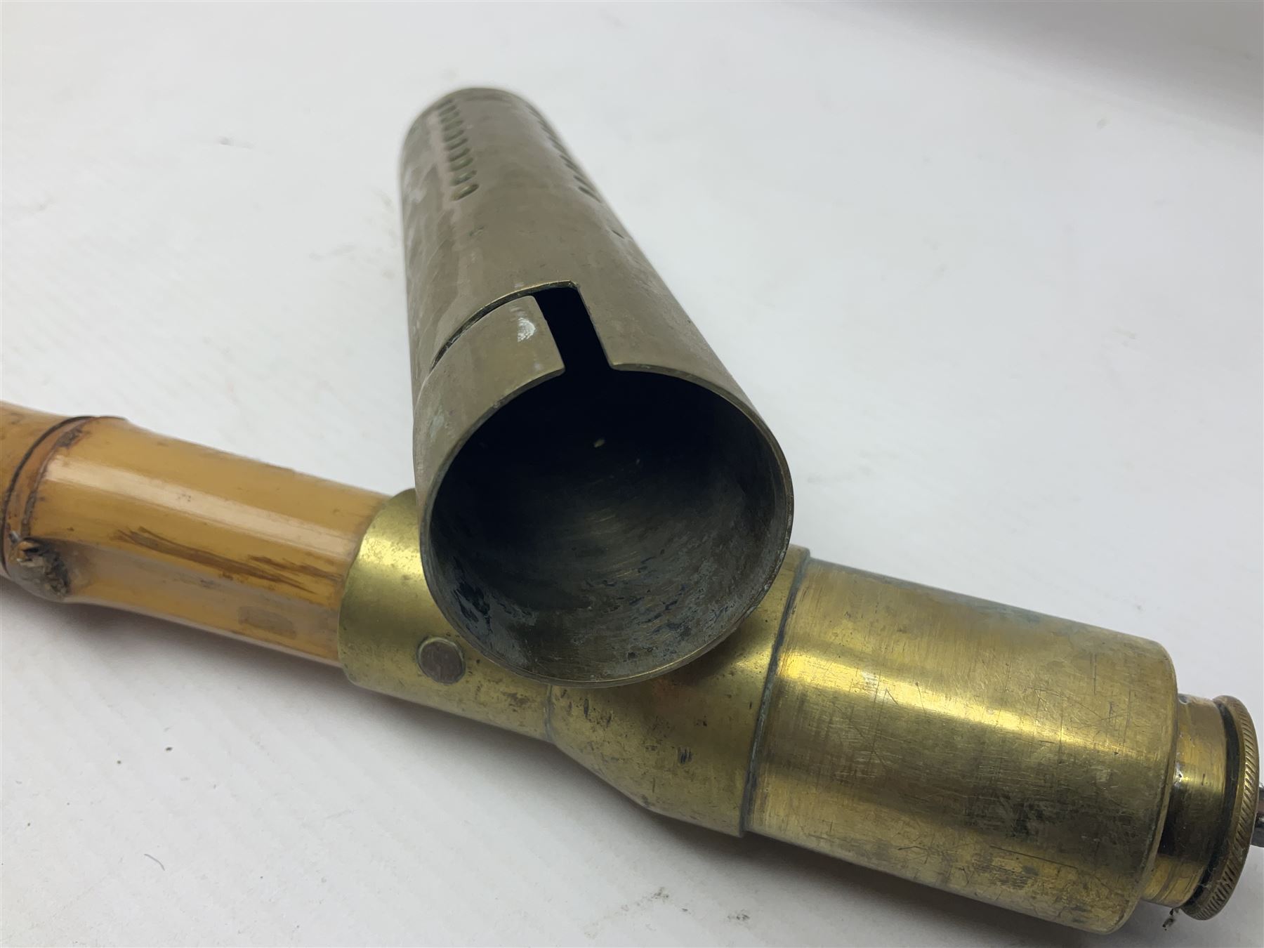 Bamboo cane torch, the pierced brass cover opening to reveal a wick, H144cm