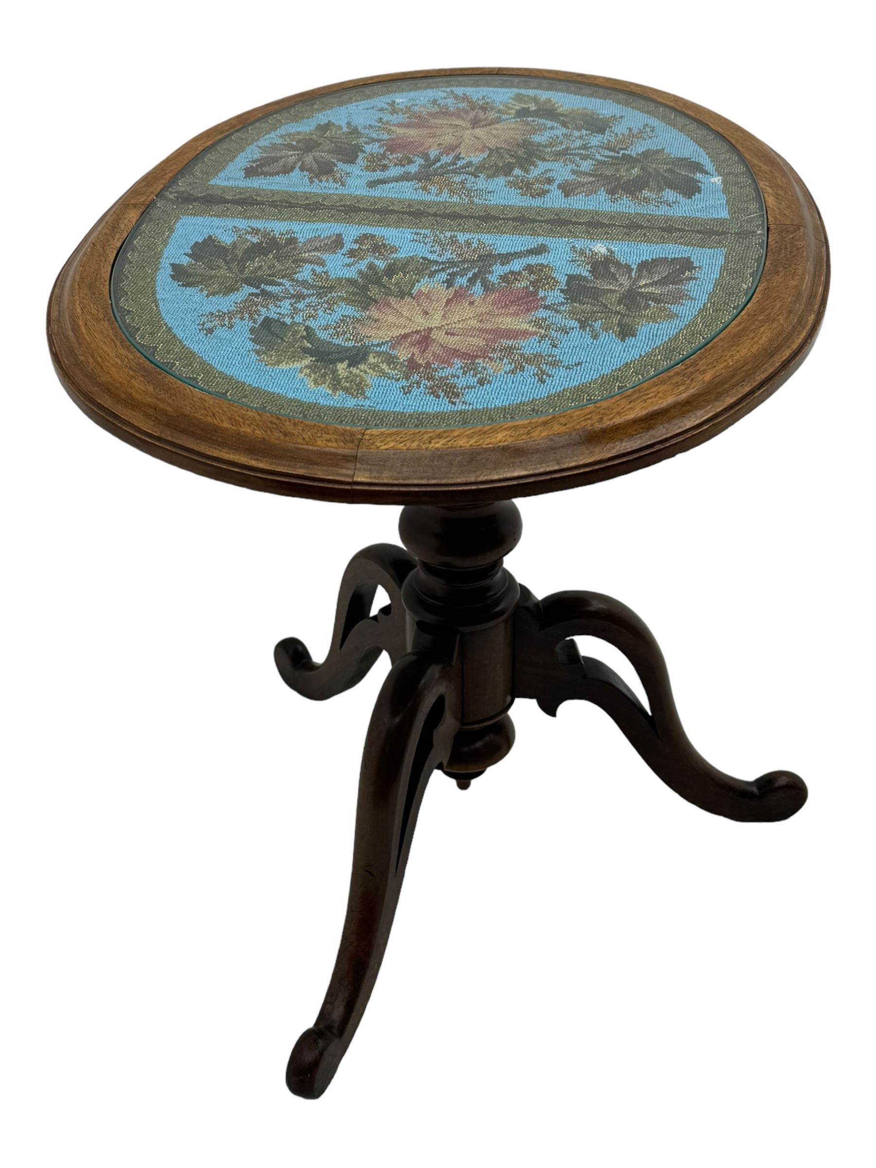 Victorian mahogany pedestal table, oval top inlaid with tapestry under glass, turned central pedestal with pointed finial, on three carved scroll supports