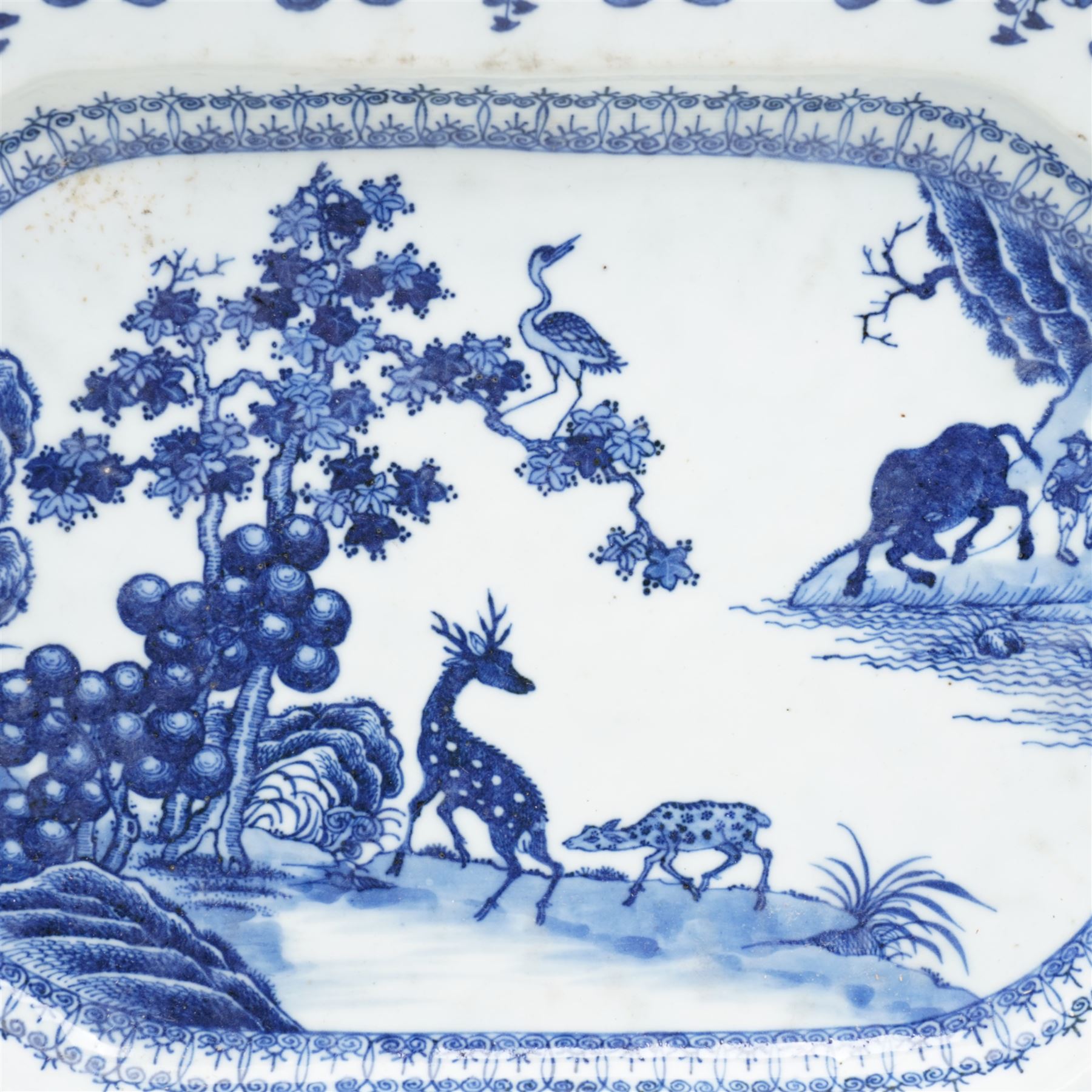 18th century, Qianlong period, Chinese Export blue and white octagonal serving platter, decorated with a figure with a buffalo, two deer and a crane by a river bank, amid foliage and rockwork, within a lambrequin border, L38cm x W28cm 