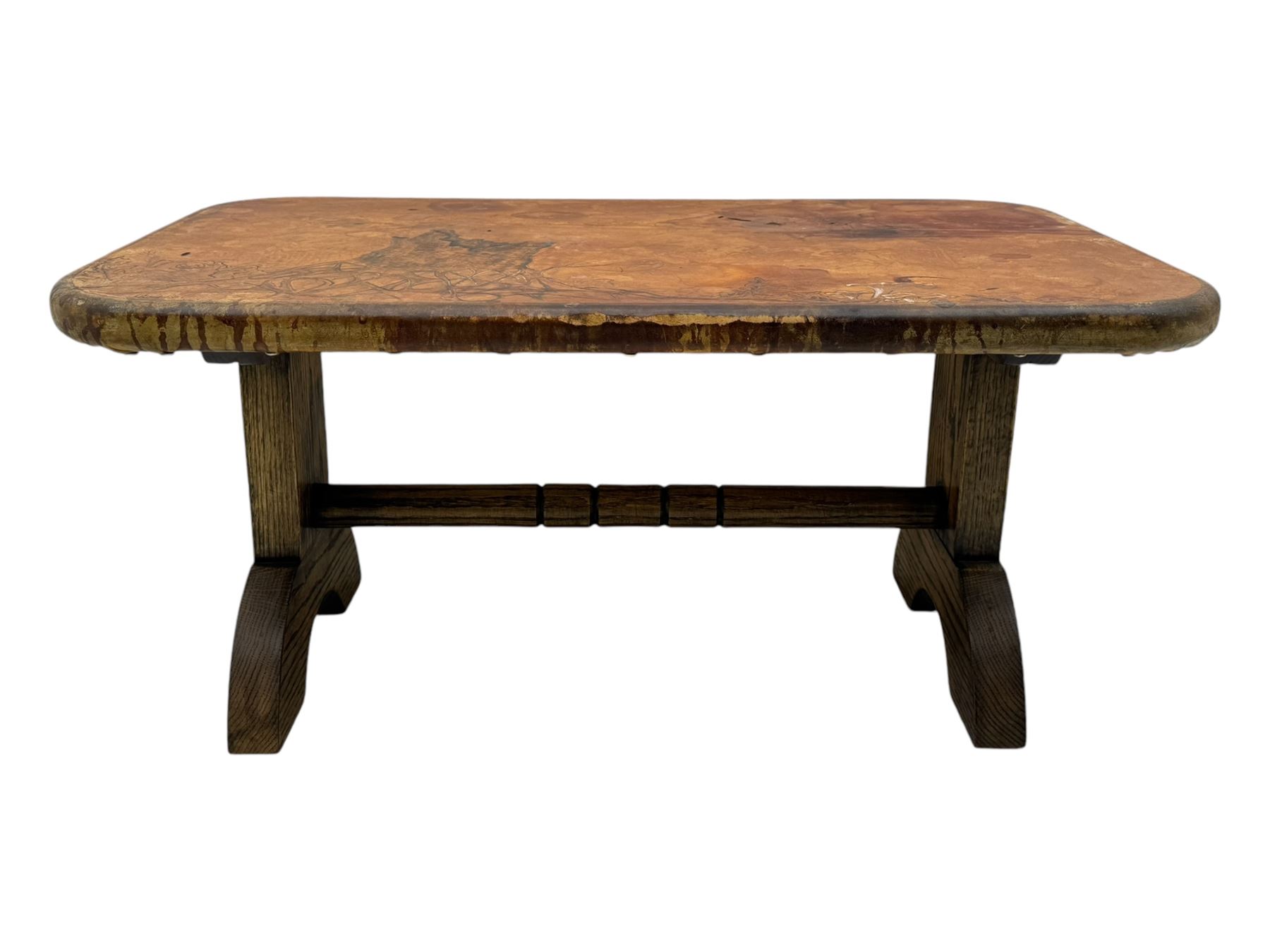 Rectangular oak coffee table, rectangular top with tan leather cover decorated with naturalistic scene, on rectangular end supports and curved feet united by turned stretcher 