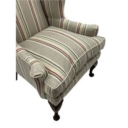 Georgian design hardwood-framed wingback armchair, curved wingback terminating to curved and rolled arms, upholstered in striped fabric with loose seat cushion, on cabriole front feet 