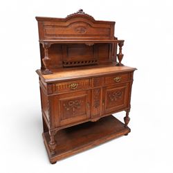 Early 20th century oak sideboard with raised back, the arched panelled back carved with ri...