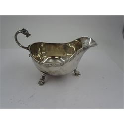 Early 20th century silver sauce boat, of typical form with flying scroll handle, the handle and feet modelled as Viking style dragon heads, hallmarked Adie Brothers Ltd, Birmingham, date mark indistinct, possibly 1940, including handle H9cm