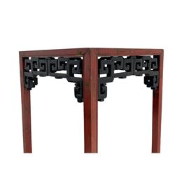 Late 19th century Chinese Qing dynasty red and black lacquered wood tall tea table, Shanxi region, square top over geometric scroll fretwork panels, on square supports with hoof feet 