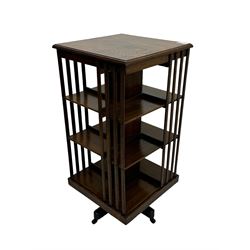 Early 20th century oak revolving bookcase, moulded square top over three tiers, with moulded vertical slats, on four spoke base with castors 