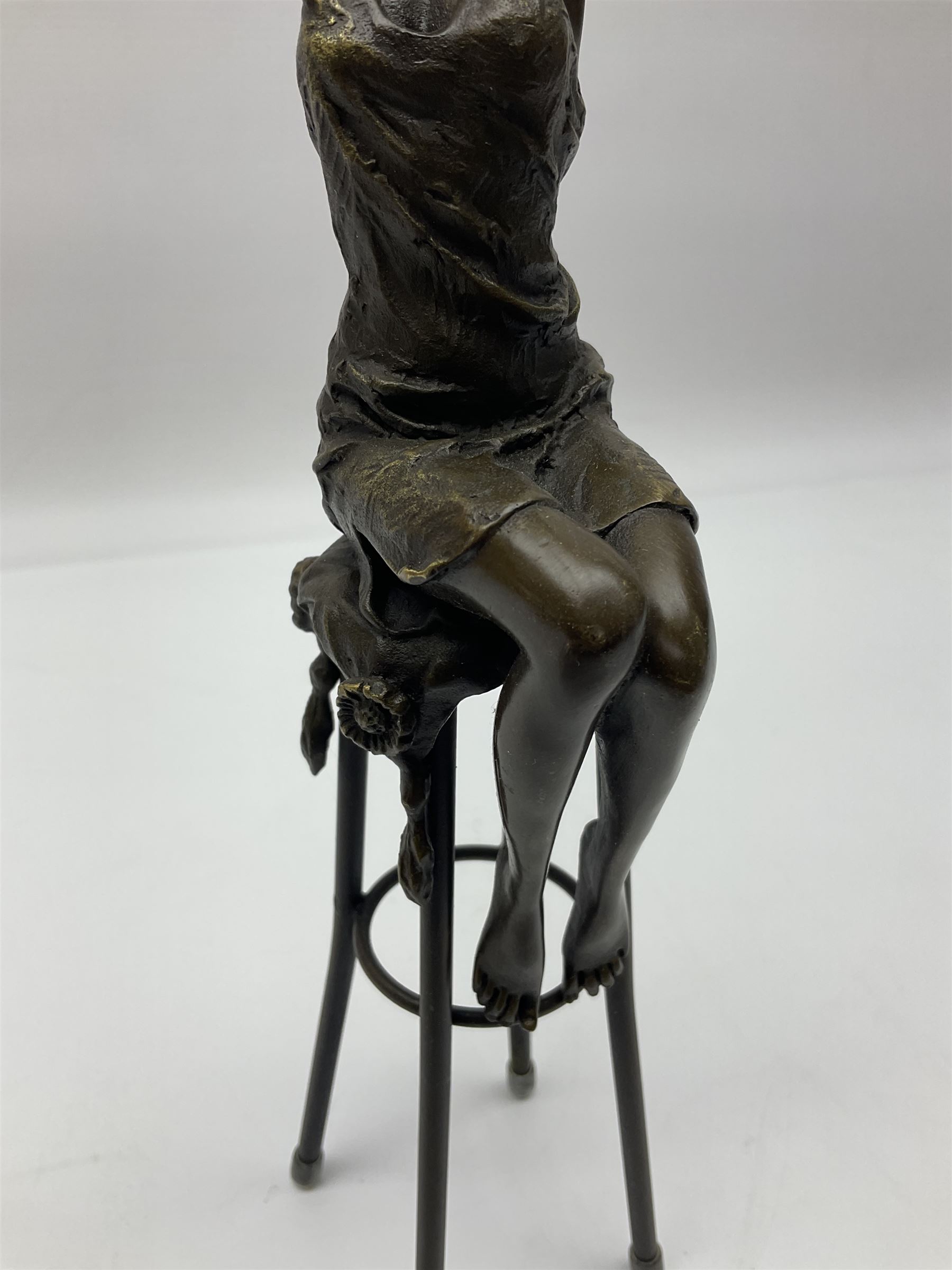 Art Deco style bronze modelled as a female figure seated upon a chair, after 'Pierre Collinet', H28cm