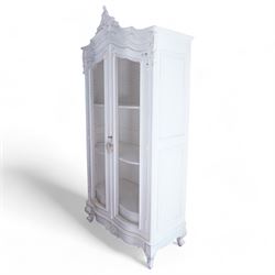 French design white painted and carved armoire, arched pediment with moulded scrolling foliate decoration, fitted with two wire-work doors enclosing three shelves, raised on acanthus carved cabriole feet