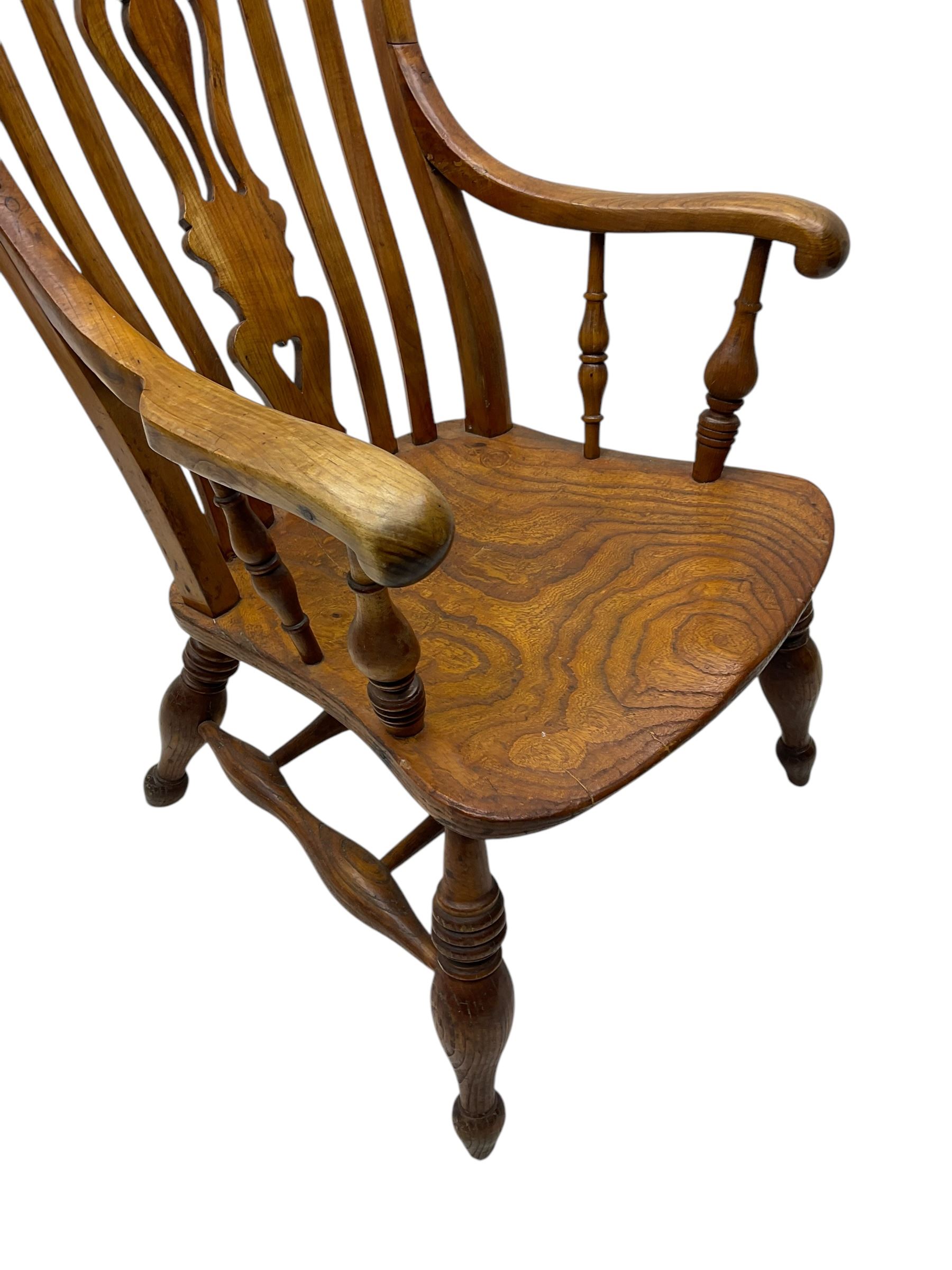 Late 19th century elm and ash comb-back Windsor chair, shaped back with pierced vase-shaped central splat and spindle supports, shaped saddle seat raised on turned supports united by H-stretcher