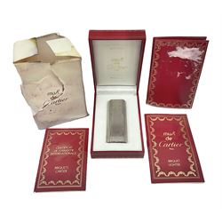 Must de Cartier stainless steel lighter, with gold plated accents, stamped Cartier to base, boxed with guarantee