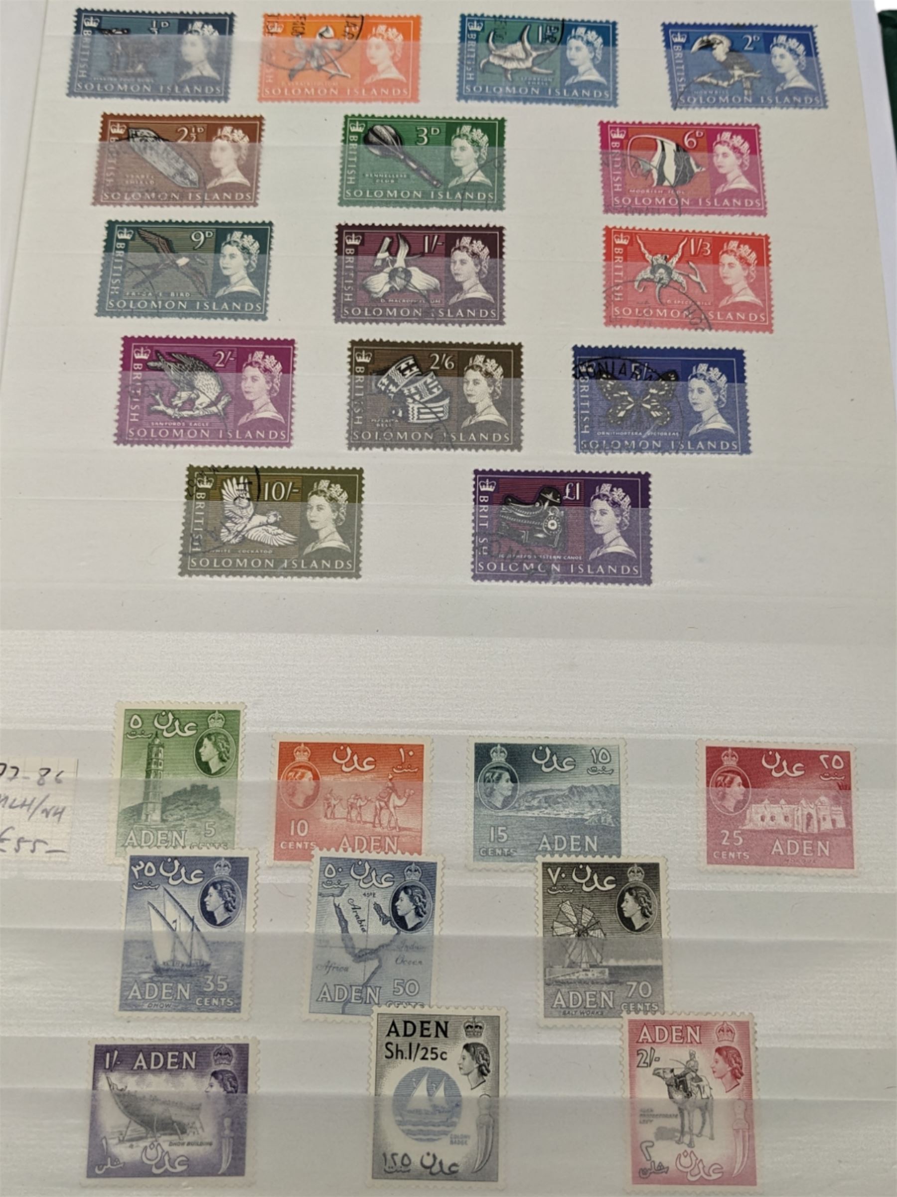 Mostly Commonwealth or Empire stamps including Queen Elizabeth II Northern Rhodesia, Nyasaland, Solomon Islands, Aden, Bermuda, Grenada 'Associated Statehood' overprints, King George VI Falkland Islands Dependencies with values to one shilling etc, mixture of mint and used, housed in a green stockbook