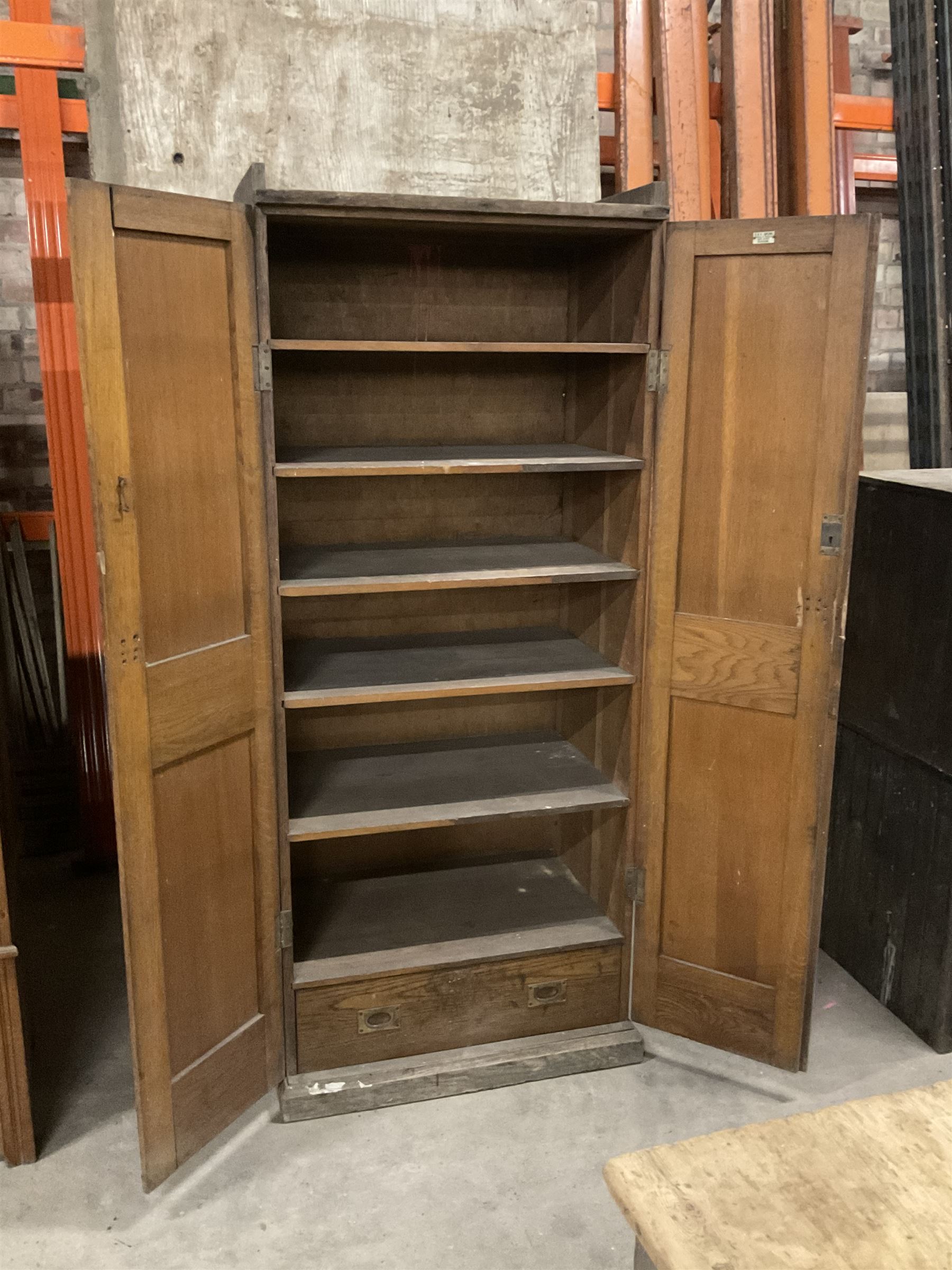 Early 20th century oak cupboard, enclosed by two panelled doors, the interior fitted with shelves and single drawer, on skirted base - THIS LOT IS TO BE COLLECTED BY APPOINTMENT FROM THE OLD BUFFER DEPOT, MELBOURNE PLACE, SOWERBY, THIRSK, YO7 1QY