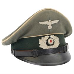 WWII German, Third Reich army NCO visor cap, green doeskin wool with a forest green centreband and cream piping, featuring a silver alloy army eagle and a silvered wreath