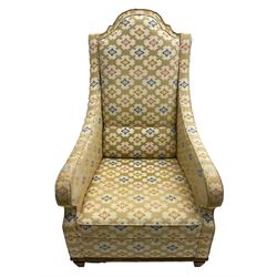 Spanish high back throne armchair, arched cresting rail over scooped arms, upholstered in gold and ivory patterned fabric, on a pitch pine base with spade feet