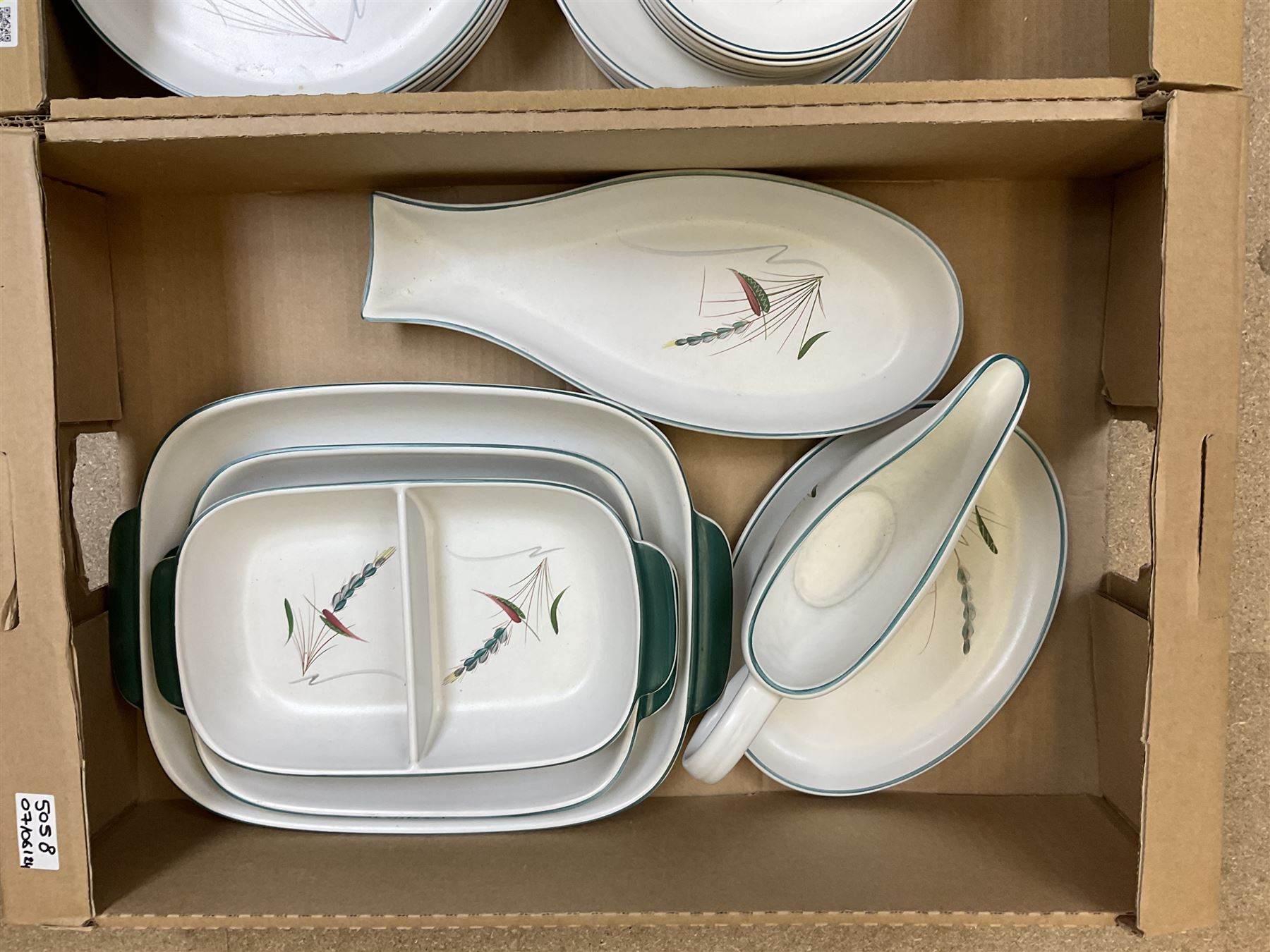 Denby part dinner service, decorated in the Greenwheat pattern, comprising dinner plates, dessert plates, side plates, lidded tureen, pair of smaller lidded dishes, sauce boat, and various serving dishes, in two boxes