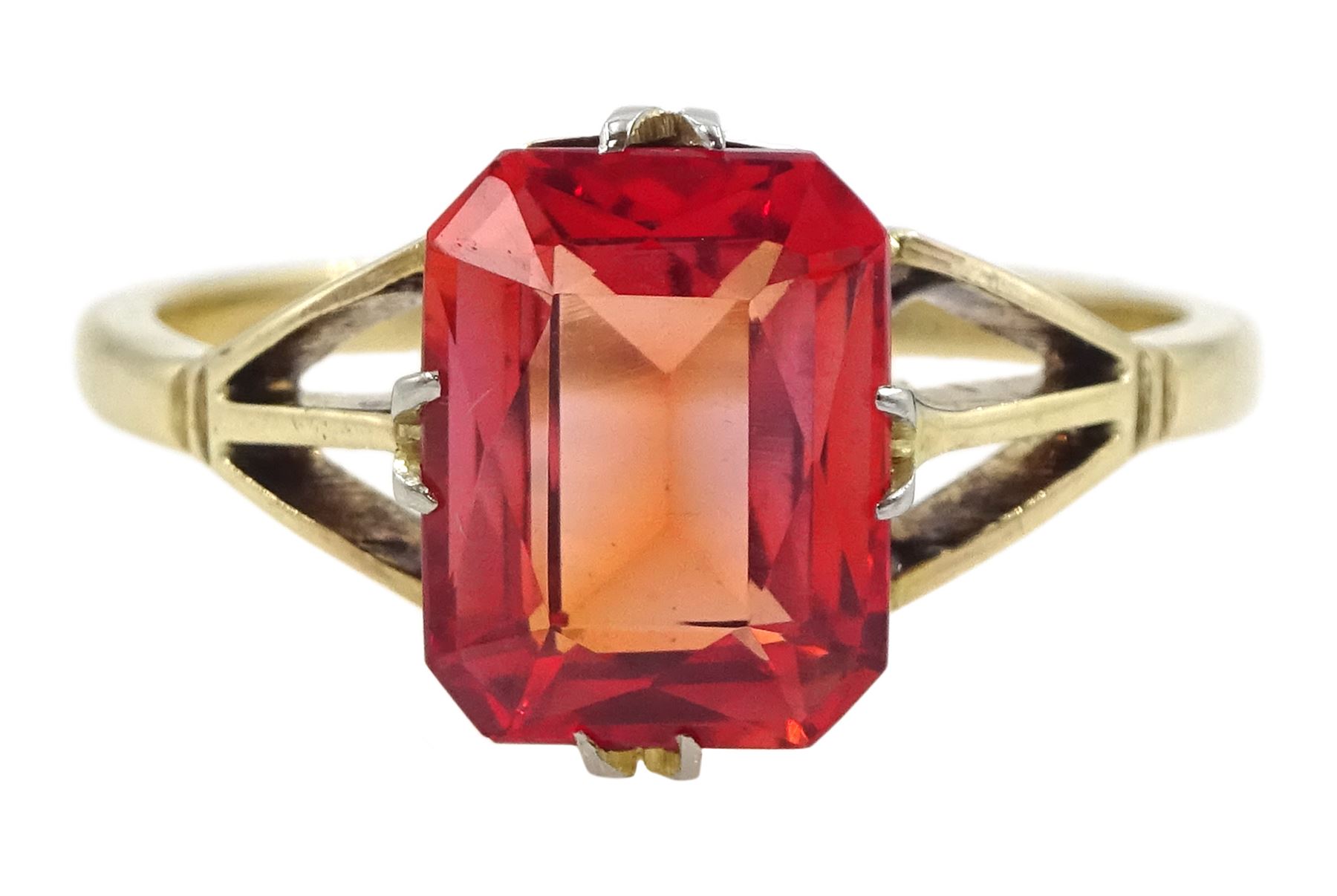 9ct gold single stone emerald cut red-orange sapphire ring, with forked shoulders