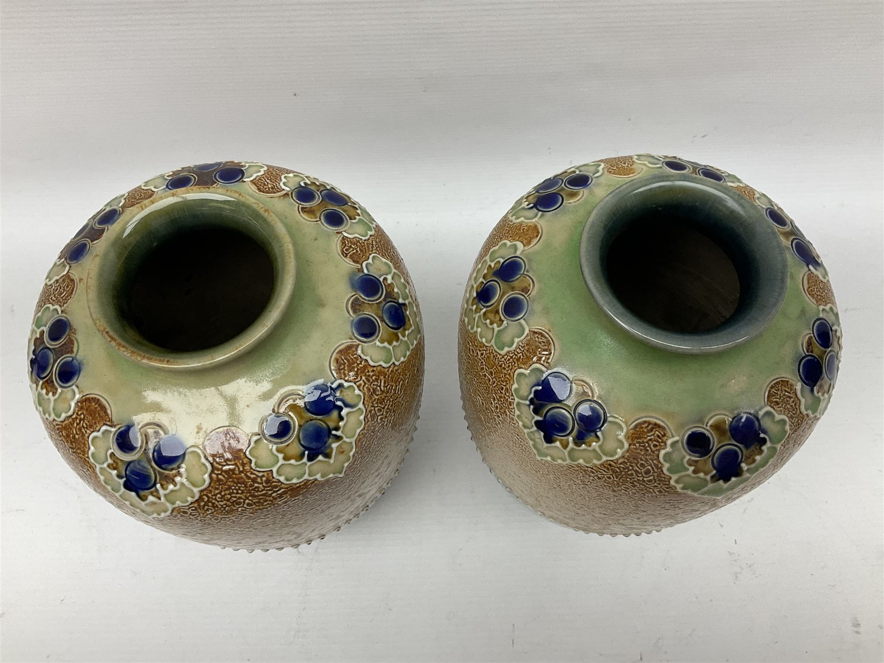 Pair of Royal Doulton Lambeth stoneware baluster vases, decorated in light relief with foliage, impressed mark beneath, H23cm