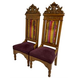 Set of six 20th century Carolean design oak high back chairs, the pediment carved with dragons and central Green Man mask with trailing foliage, the backs upholstered in striped fabric, on turned front supports