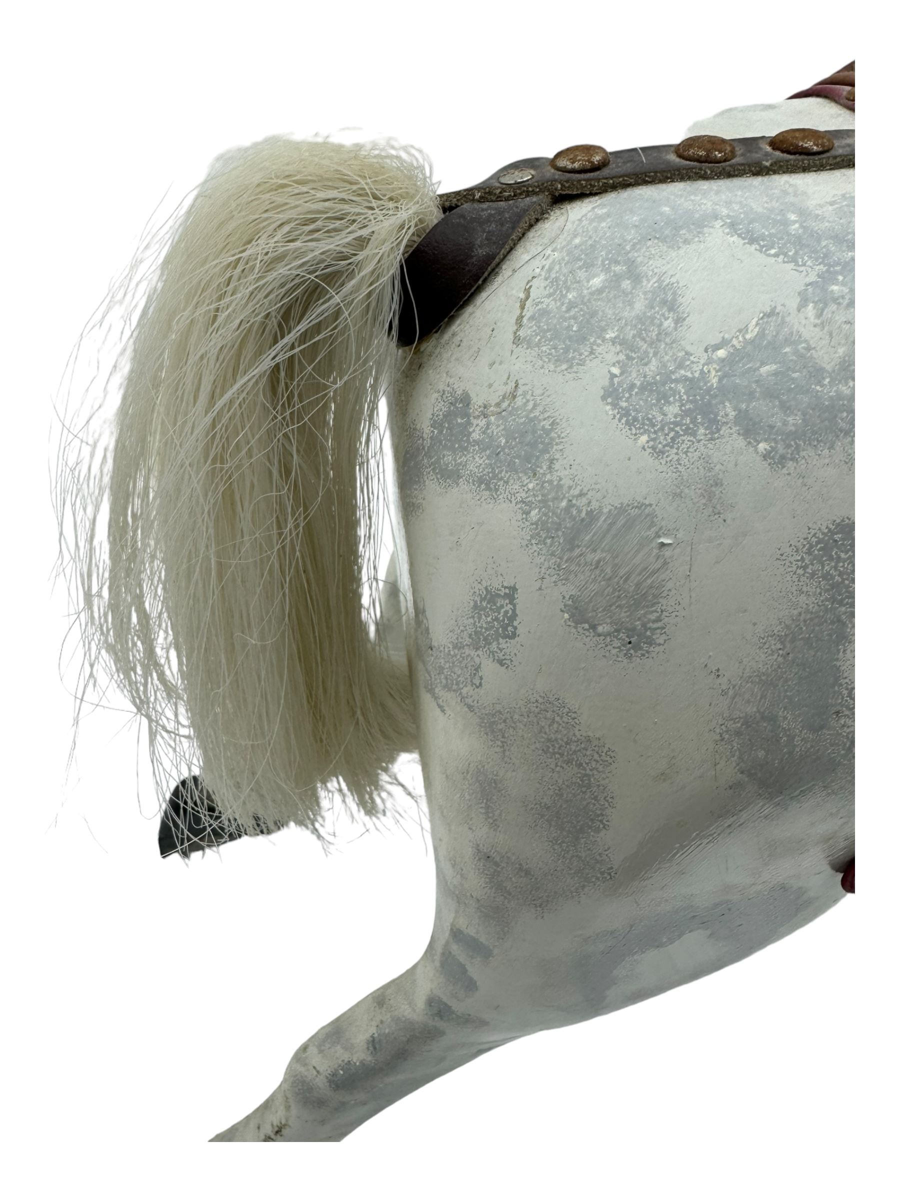 Mid 20th century rocking horse, dappled grey painted horse with applied mane and tail, red leather saddle and bridle accented with brass studs, supported by a stained wooden frame with turned supports and iron brackets, mounted on rockers