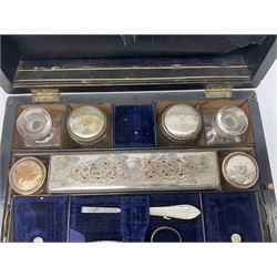 Walnut dressing table box, set with mother of pearl cartouche engraved with initials to hinged cover, opening to reveal a fitted velvet interior containing glass bottles and jars with engraved silver plated lids, box H17cm