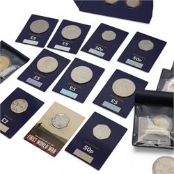 Mostly commemorative coinage, including The Royal Mint United Kingdom 2014 'Outbreak' fine silver twenty pound coin on card, various five pound coins with some on cards, commemorative fifty pence pieces, Queen Elizabeth II Tuvalu 2018 'Silver Thermometer' two dollars two ounce fine silver coin etc