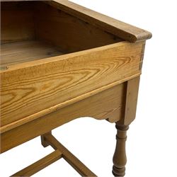 Early 20th century pitch pine clerk’s desk, stripped mahogany sloped hinged top, raised on turned supports