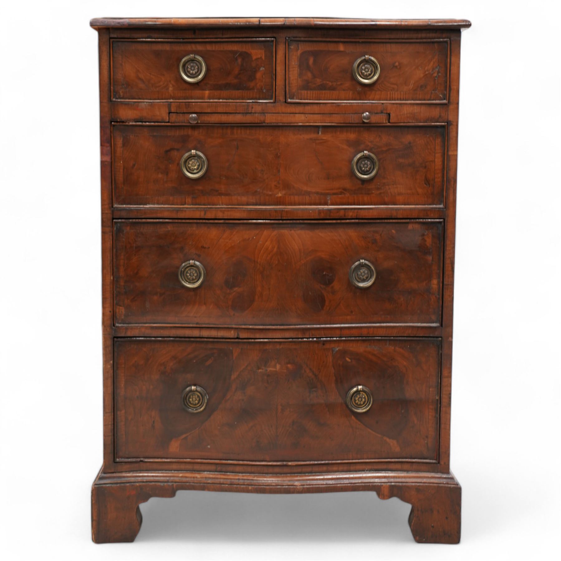 Georgian design yew wood serpentine chest, moulded and crossbanded top over two short and three long graduating cock-beaded drawers, circular pressed brass handle plates with hoop handles, fitted with slide, on bracket feet