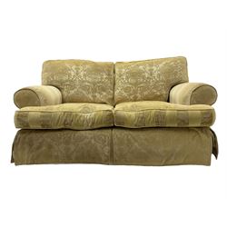 Contemporary two-seat sofa, upholstered in damask fabric with a pale gold floral pattern, rolled arms, loose back and seat cushions, on matching skirted base with concealed castors