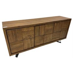 Samba 'Camden' oak sideboard, rectangular top over three block panelled cupboard doors, raised on angled black metal supports connected with stretcher