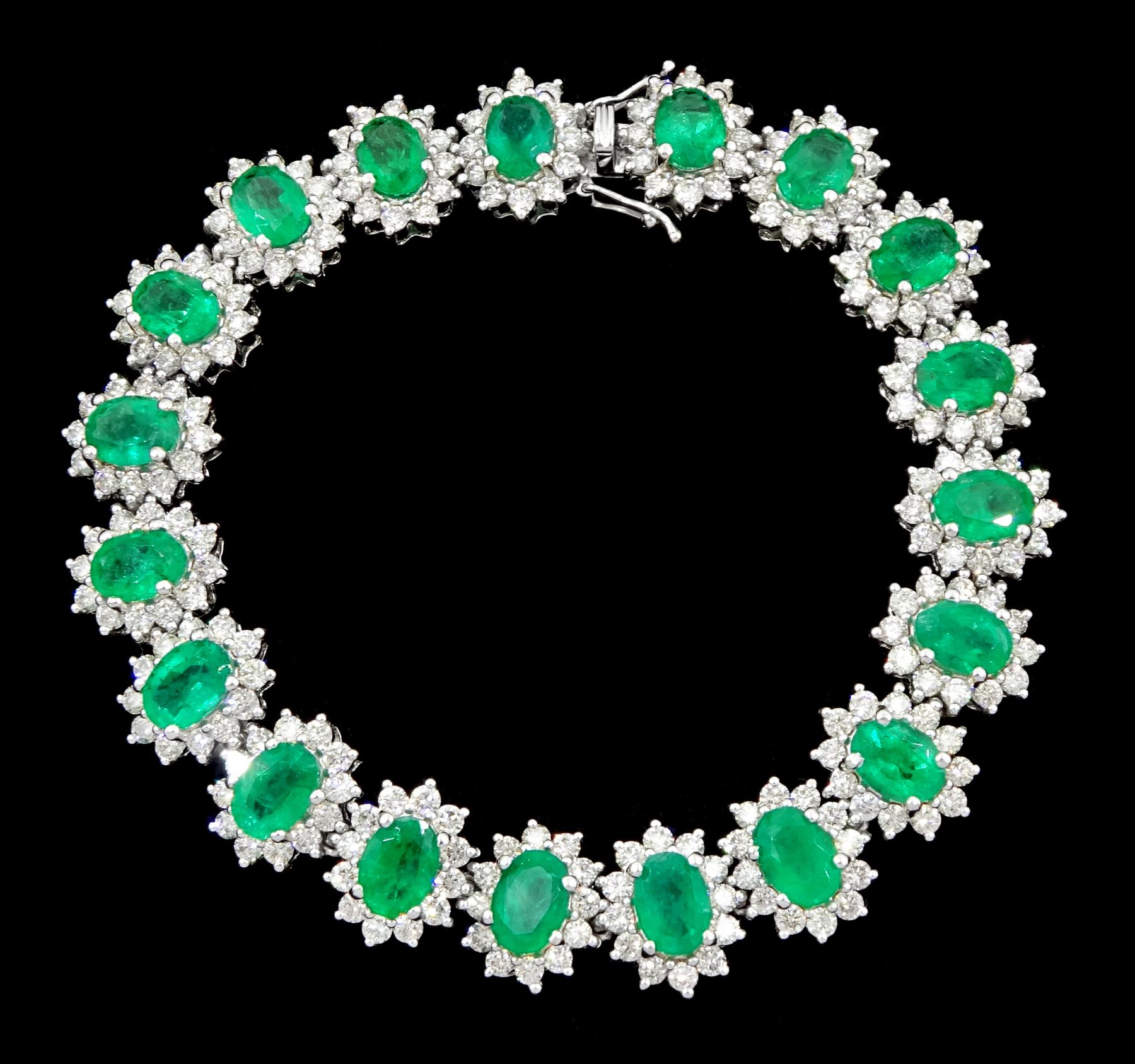 18ct white gold oval emerald and round brilliant cut diamond cluster bracelet, stamped 750, total emerald weight 14.70 carat, total diamond weight 7.24 carat