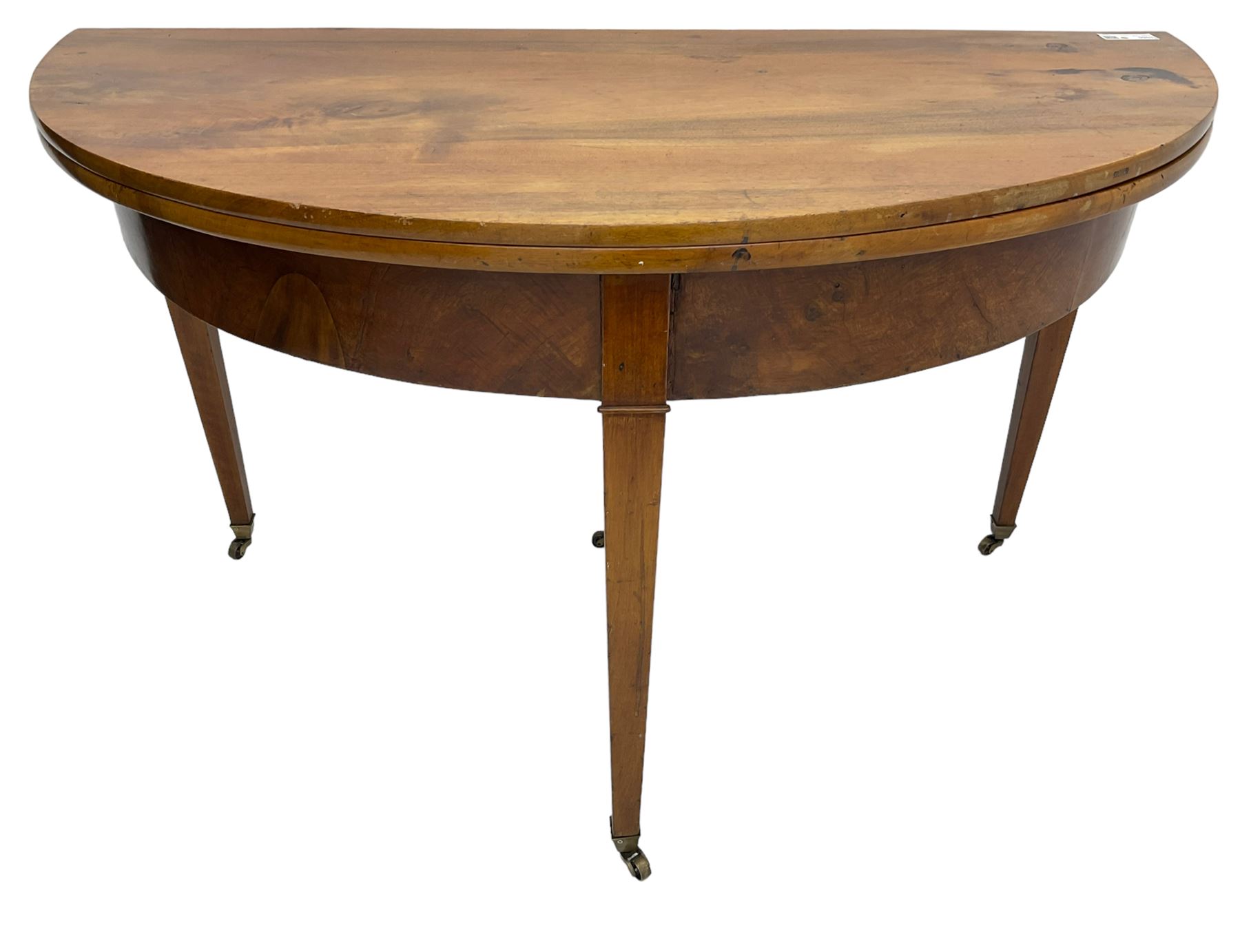 19th century mahogany demi-lune console table, hinged fold-over top with single drawer, on tapered supports with brass castors