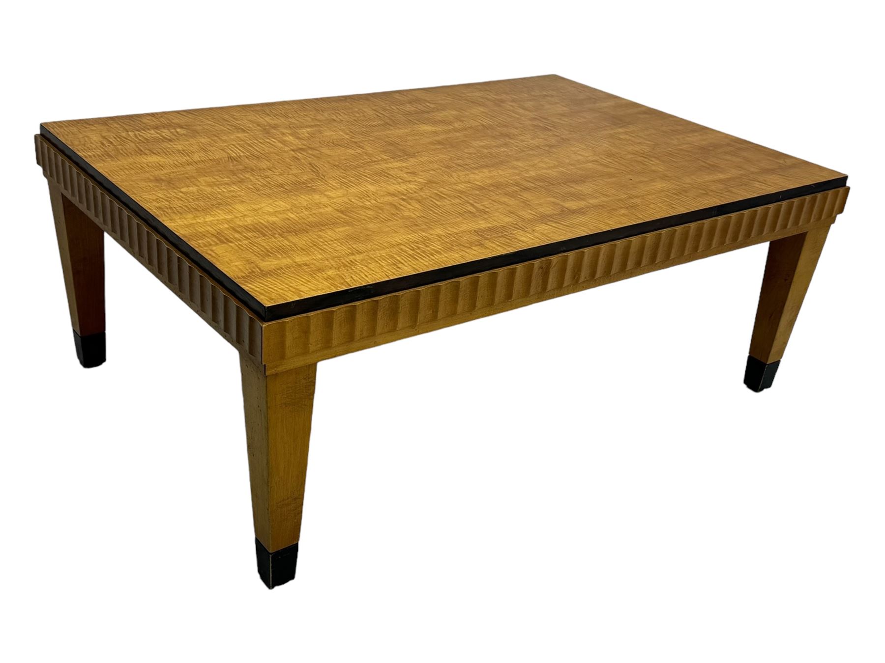 Art Deco design maple wood coffee table, rectangular top with reeded edge, on tapered supports with metal feet protectors