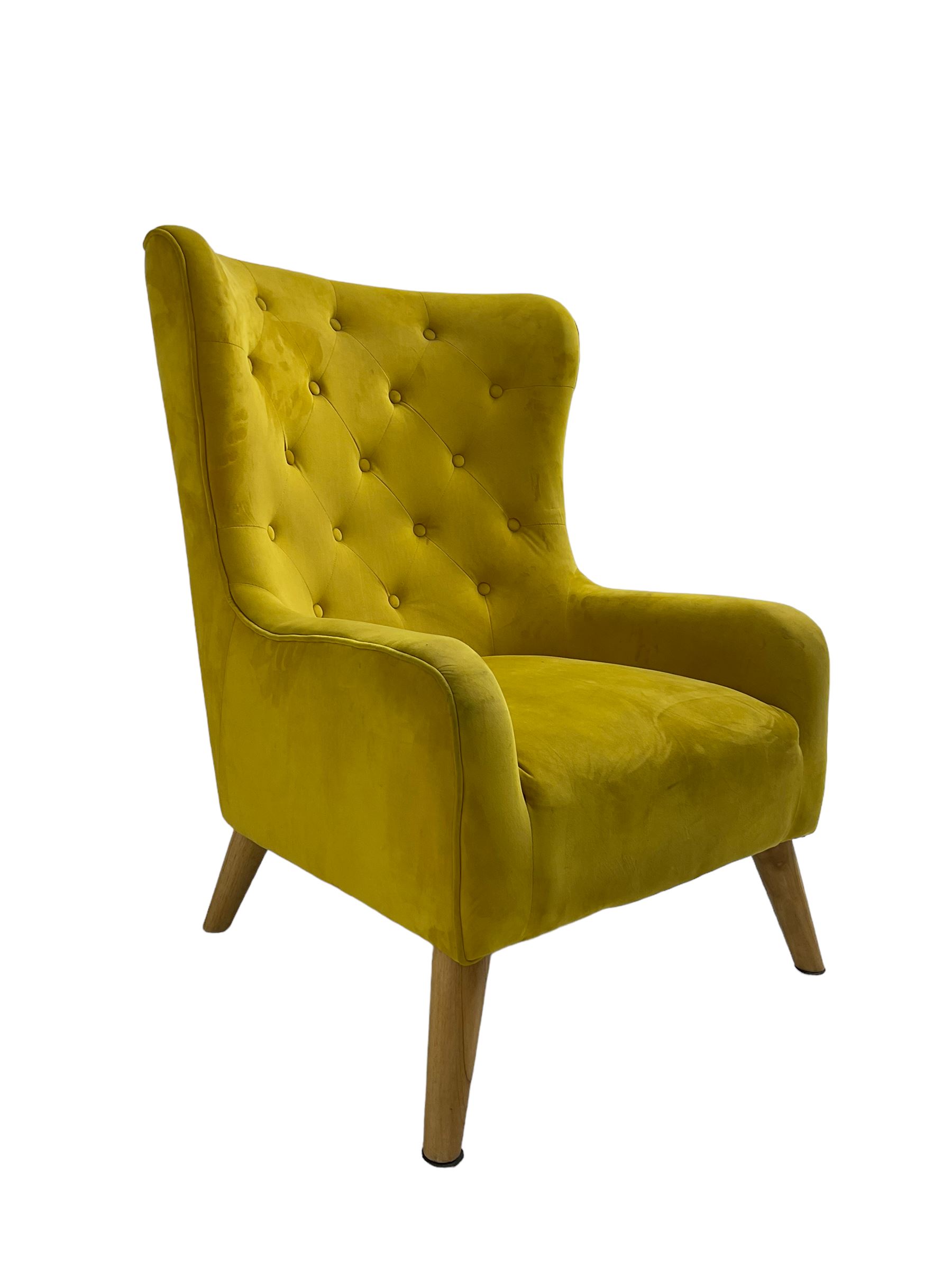 Mid-20th century design armchair, barrel back upholstered in buttoned mustard fabric, on tapering splayed front feet