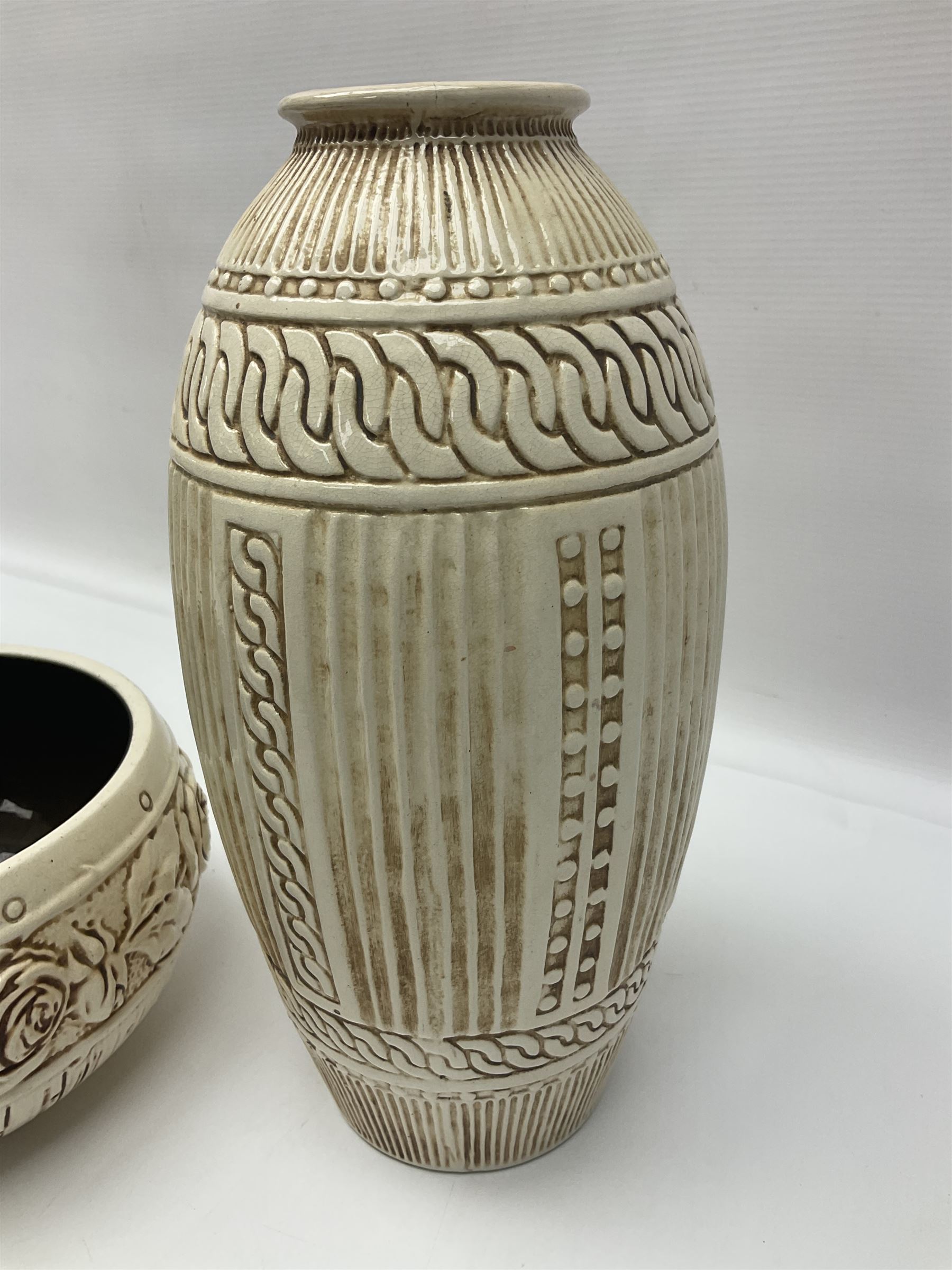 Bretby vase, of baluster form, with fluted and chain link decoration upon an ivory ground, together with a similar Bretby bowl, decorated with a band of roses upon an ivory ground, both with impressed marks beneath, and one other vase, with relief floral decoration and pewter cased rim, tallest H33cm