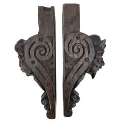 Pair of Victorian figural carved oak corbels, modelled as male and female masks, with scroll and fruit details, H22cm x W8.5cm 