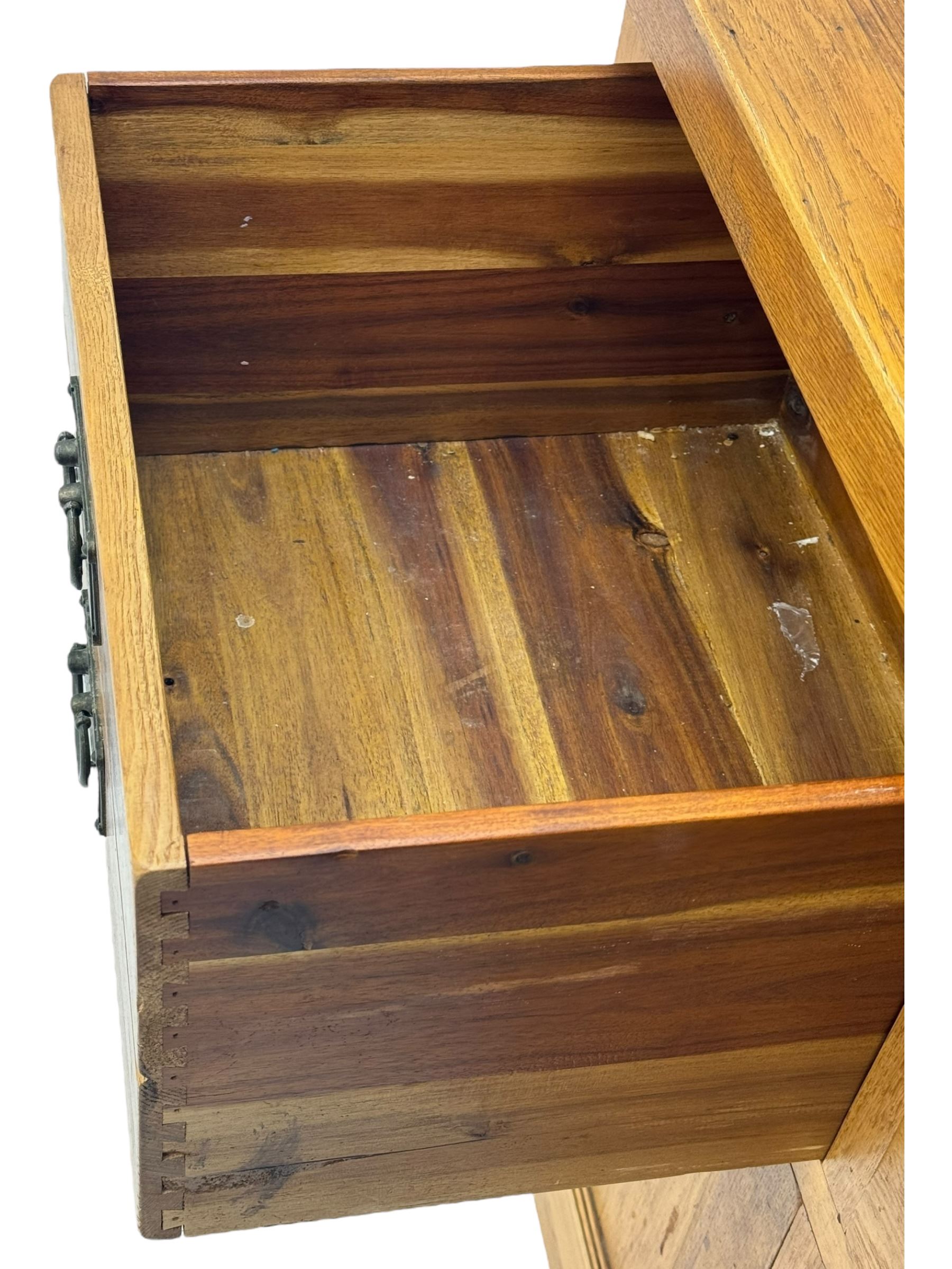 Oak dresser, upper section with twin glazed cupboard doors and central shelving with two trinket drawers, lower section fitted with six drawers over three panelled cupboard doors, raised on shaped feet 