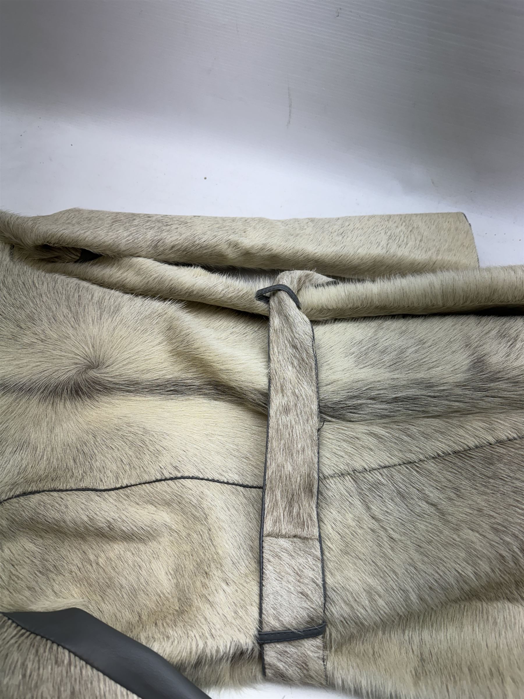 White pony hide, with grey leather sleeves and silk liner